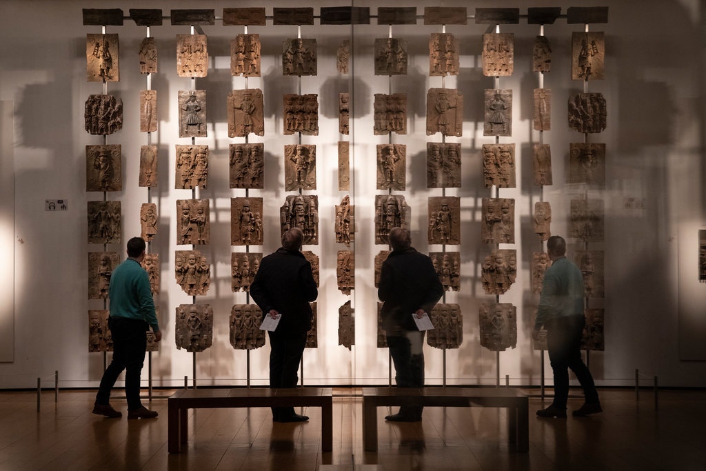 Plaques that form part of the Benin Bronzes on show at the British Museum in London. The plaques were taken by British troops in 1897.Credit...Dan Kitwood/Getty Images